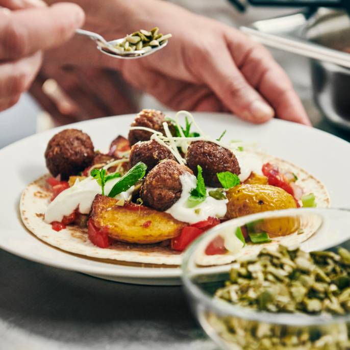 Bezmasé kuličky HUVUDROLL na talíři s přílohou.